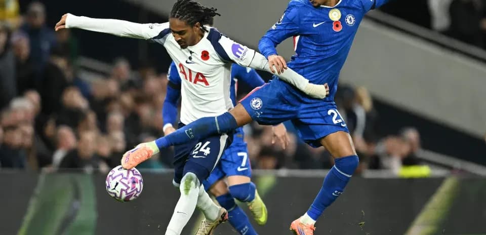 Chelsea player tackling Tottenham opponent in match