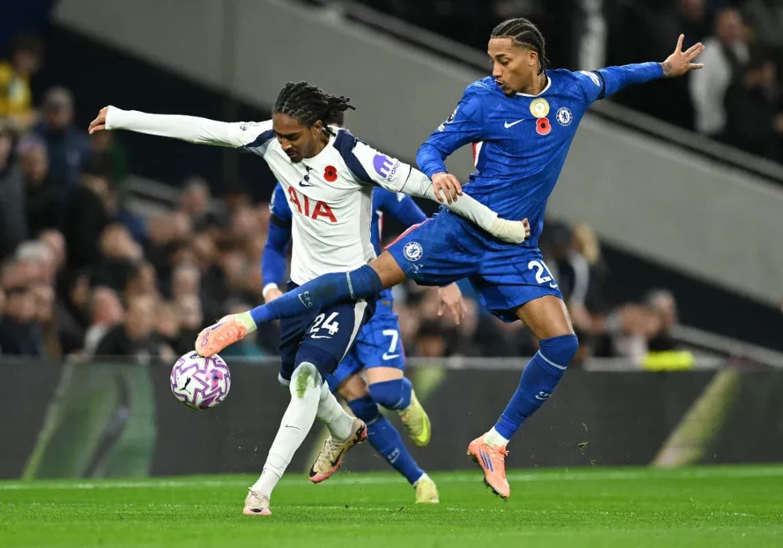 Chelsea player tackling Tottenham opponent in match