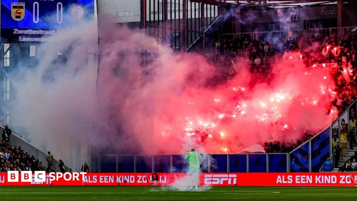 Fans lighting flares during a football match