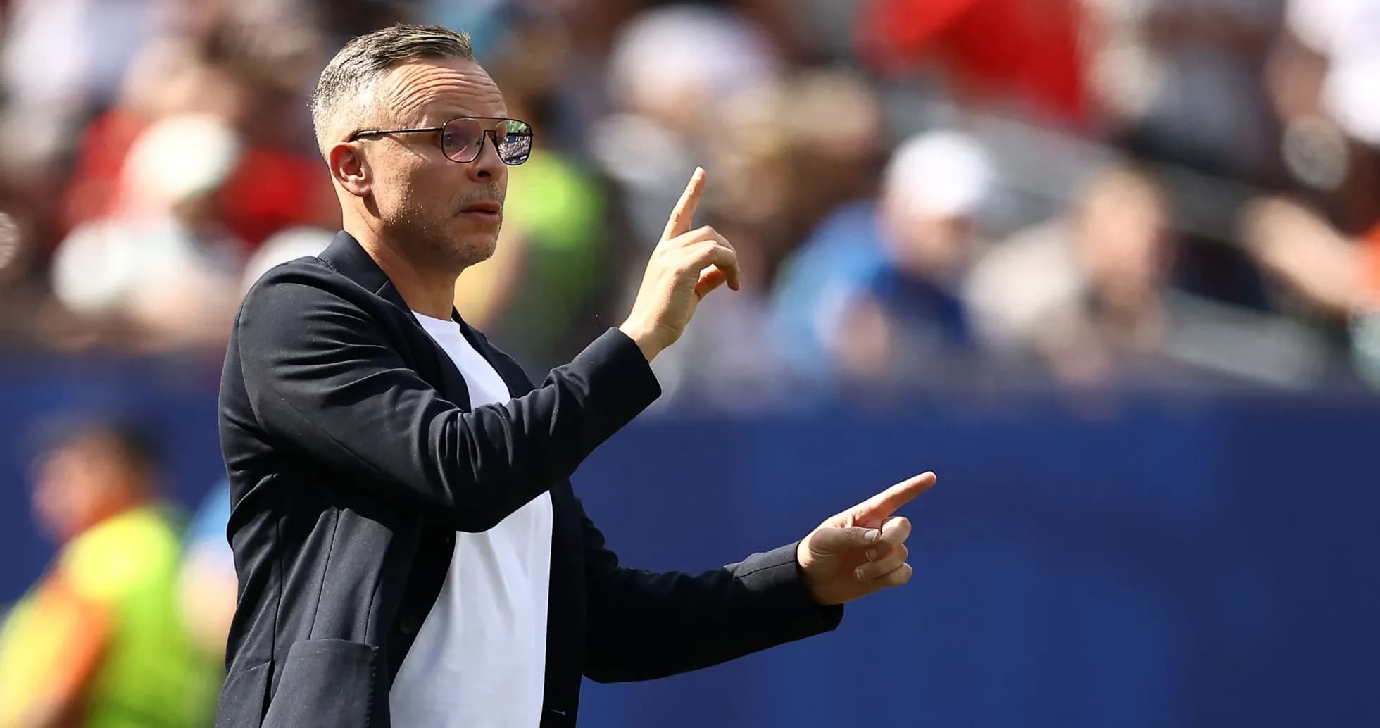 Coach gesturing during a match from the sidelines