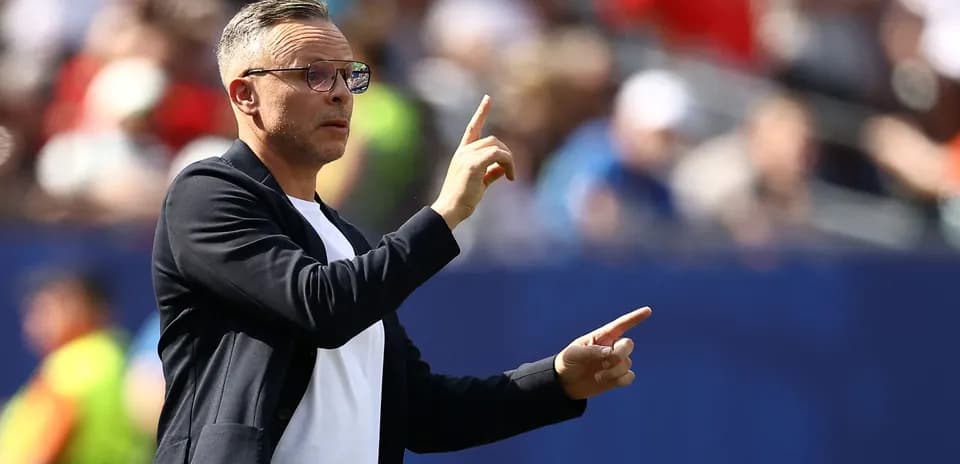 Coach gesturing during a match from the sidelines