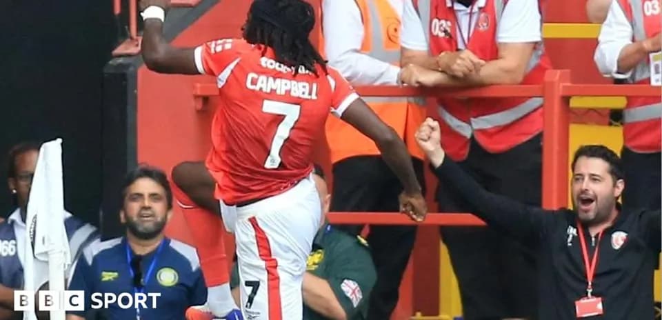 Player celebrating a goal with fans in the stands