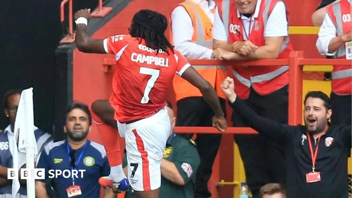 Player celebrating a goal with fans in the stands