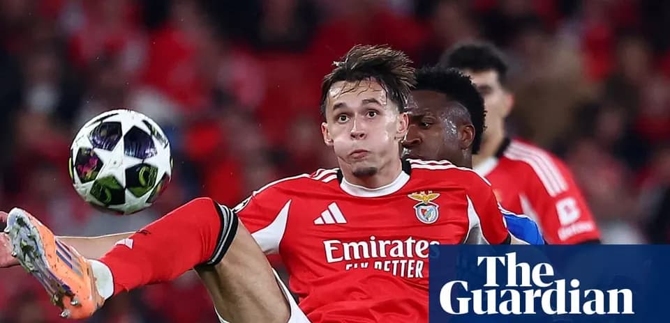 Benfica player kicking ball during match action
