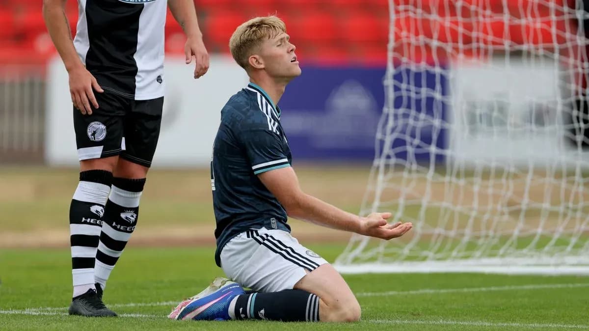 Player kneeling on field with hands raised
