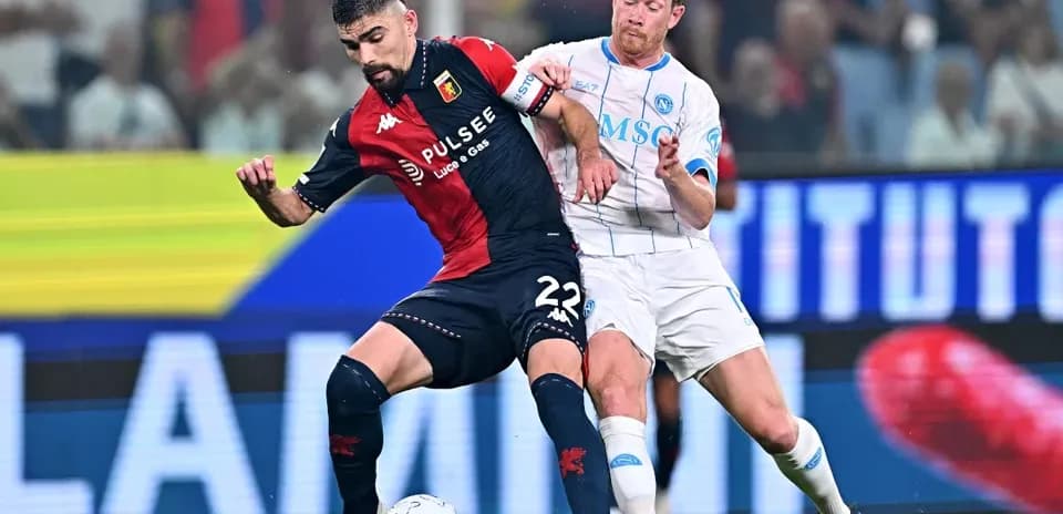 Genoa player tackled by Napoli opponent during match