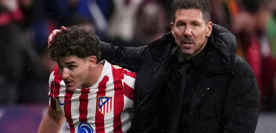 Atletico Madrid player receiving guidance from coach
