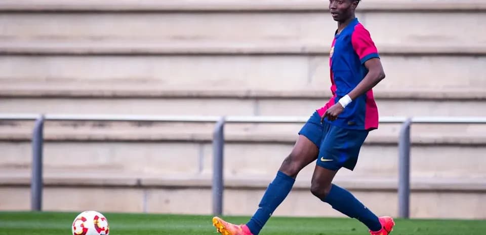 Player in Barcelona kit passing ball on field