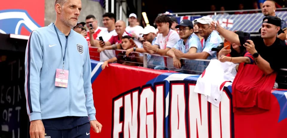 Manager walking past fans at stadium entrance