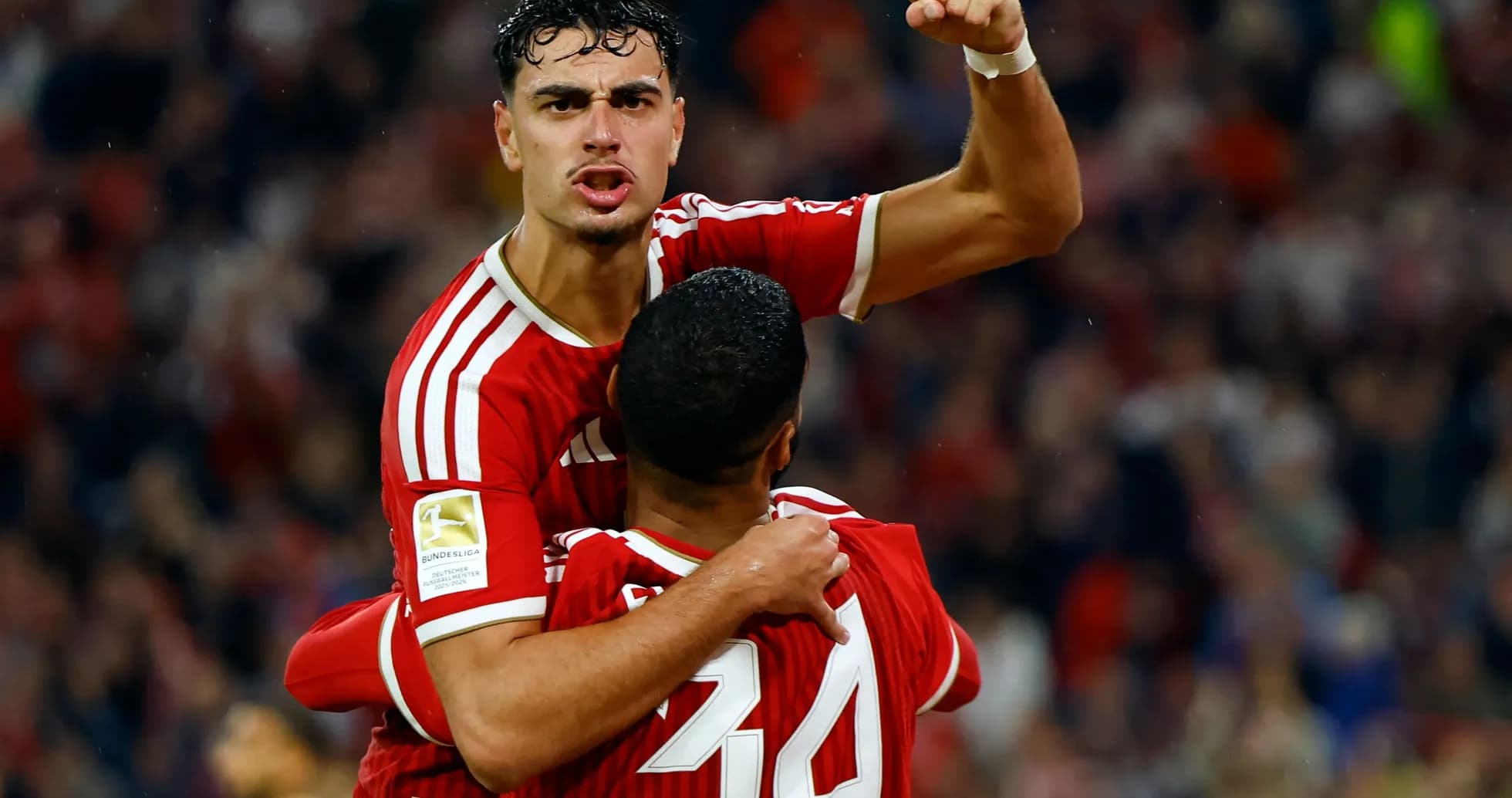Player celebrating with teammate after scoring goal