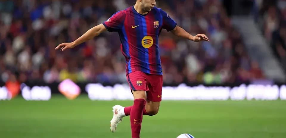 Player in Barcelona kit preparing to kick soccer ball