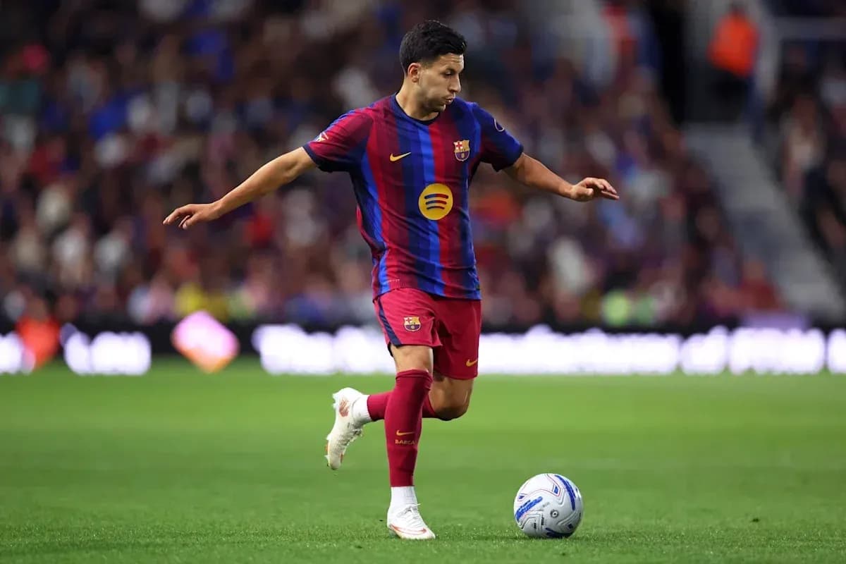 Player in Barcelona kit preparing to kick soccer ball