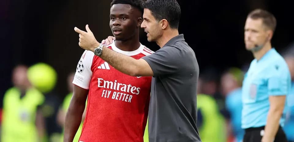 Manager discussing strategy with player on sideline