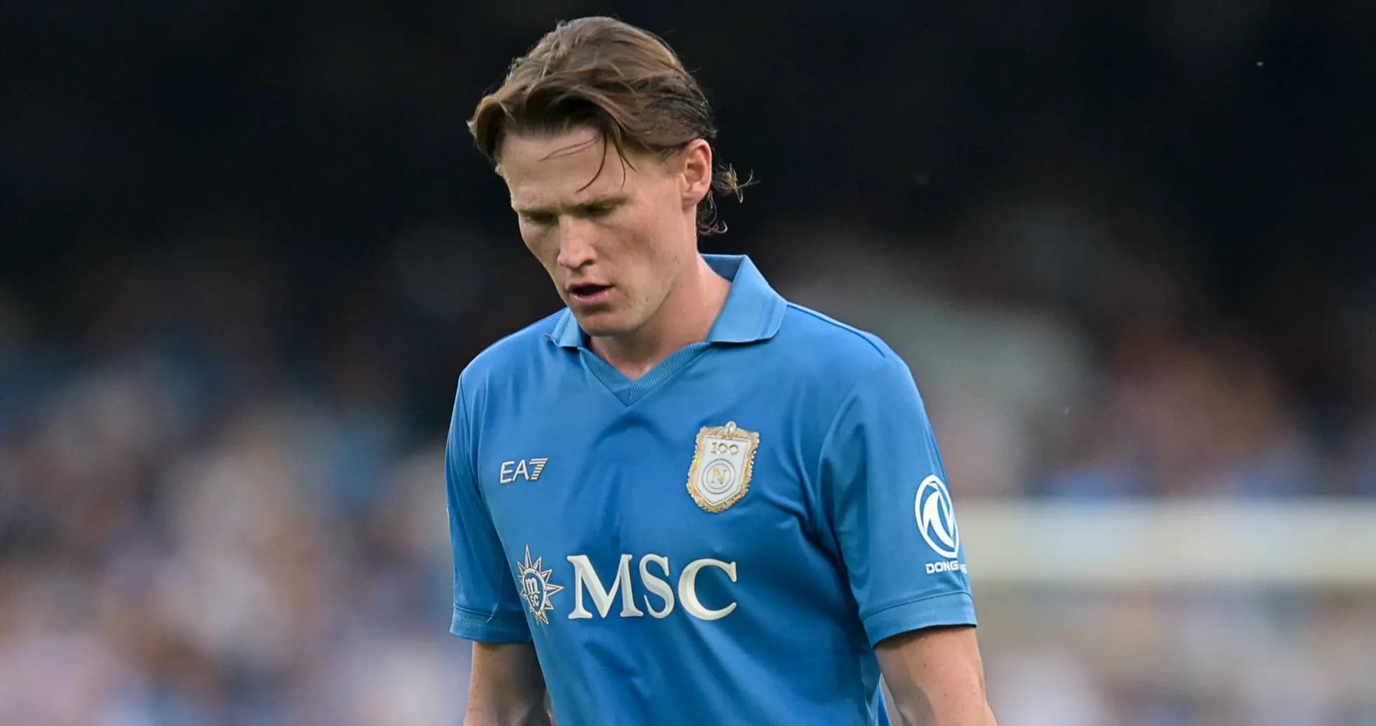 Player in blue jersey walking on the pitch