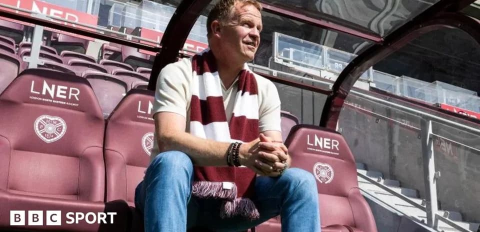 Manager sitting on team bench at stadium