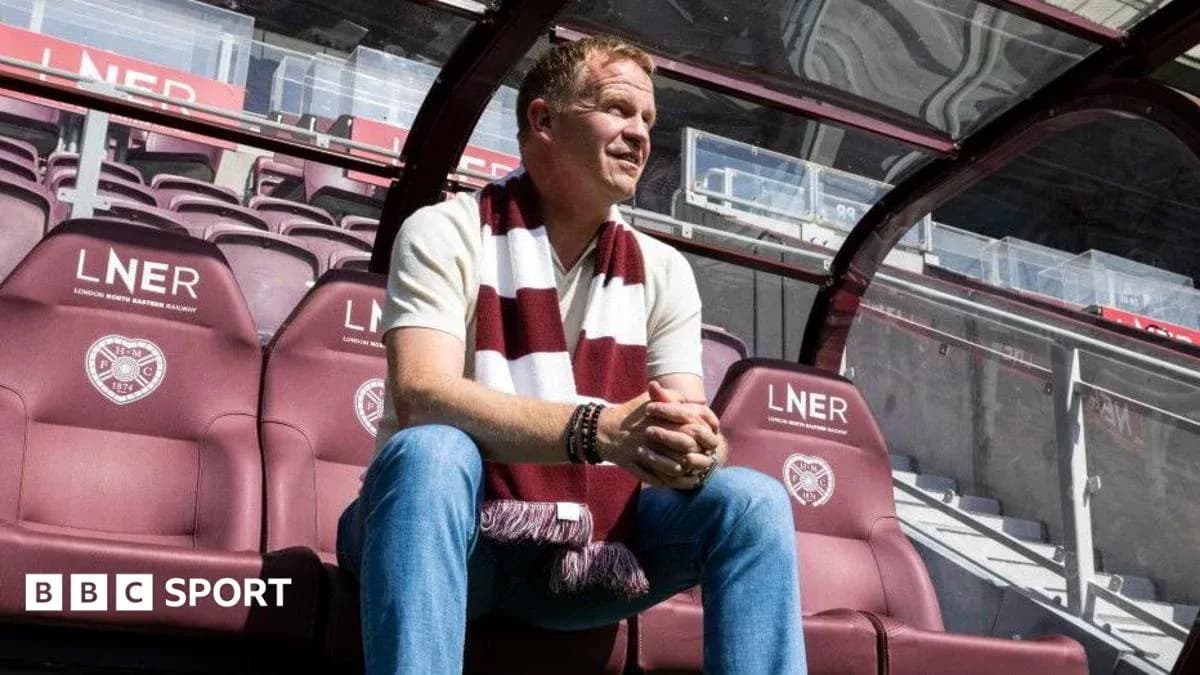 Manager sitting on team bench at stadium