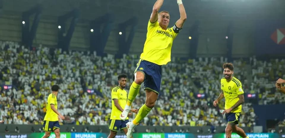 Player celebrating during match with teammates in stadium
