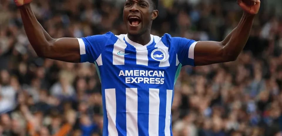 Player celebrating in Brighton home kit during match