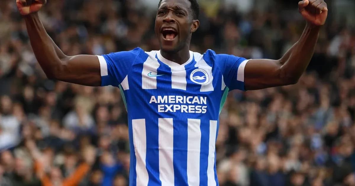 Player celebrating in Brighton home kit during match