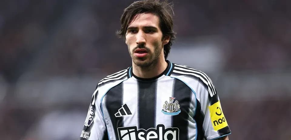 Newcastle player in striped home kit on pitch