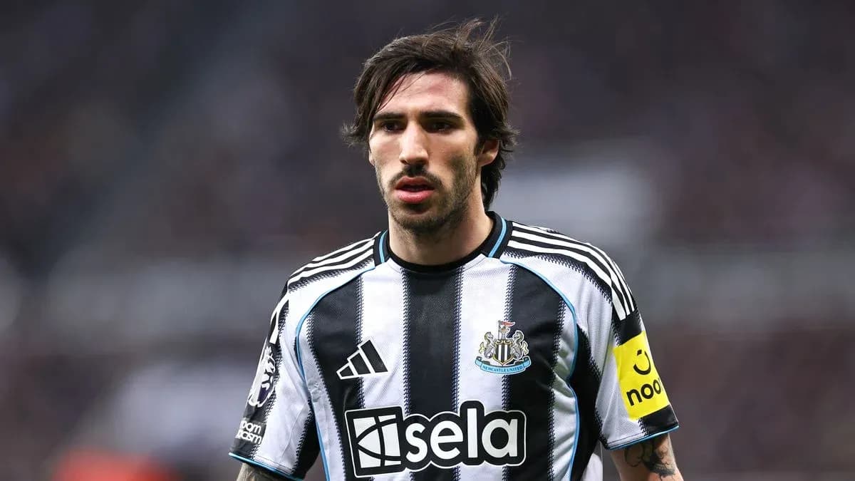 Newcastle player in striped home kit on pitch