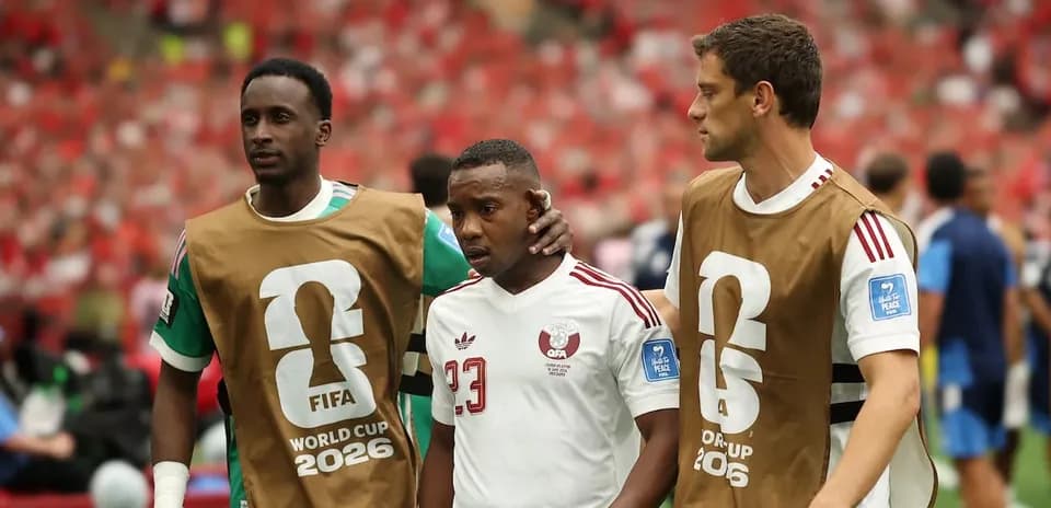 Three players walking off the field during match