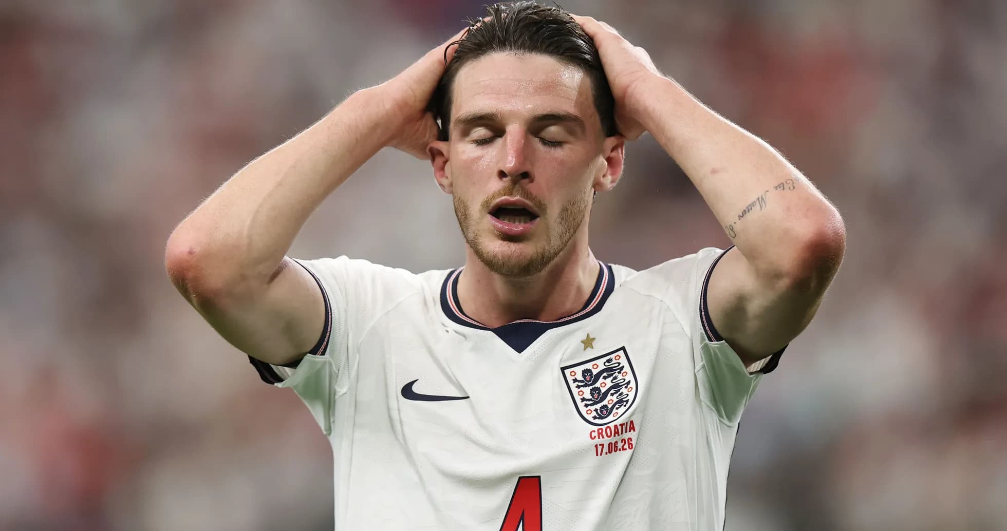 Player in England kit with hands on head