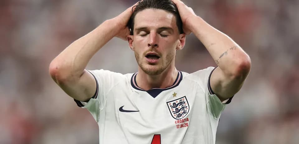 Player in England kit with hands on head