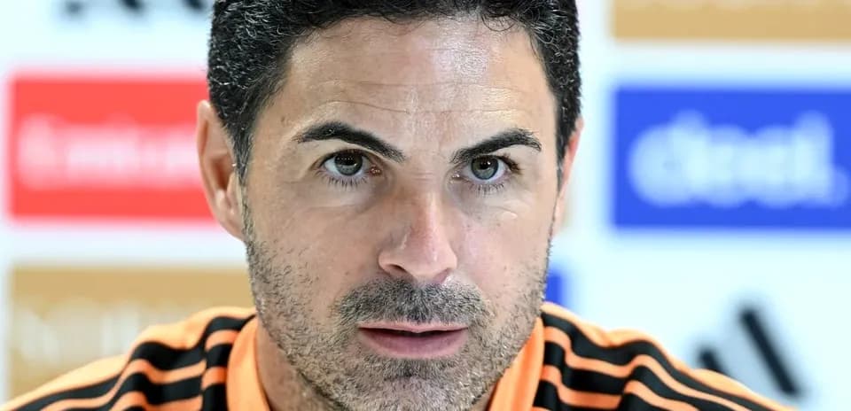 Manager at press conference with focused expression