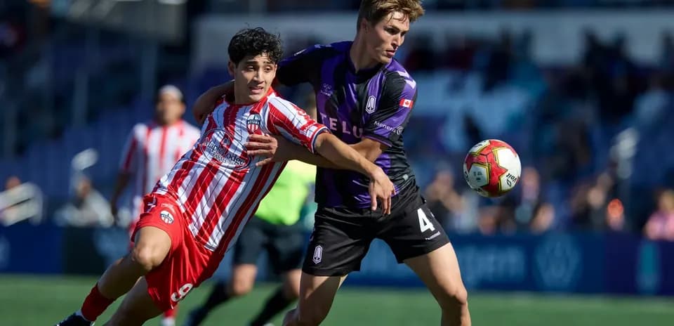 Players competing for the ball during match