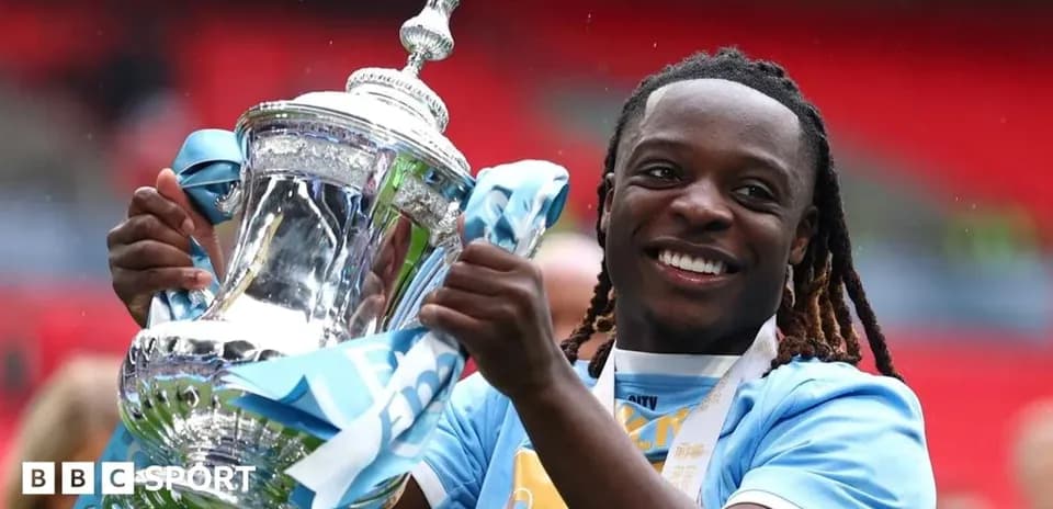Player celebrating with trophy at stadium