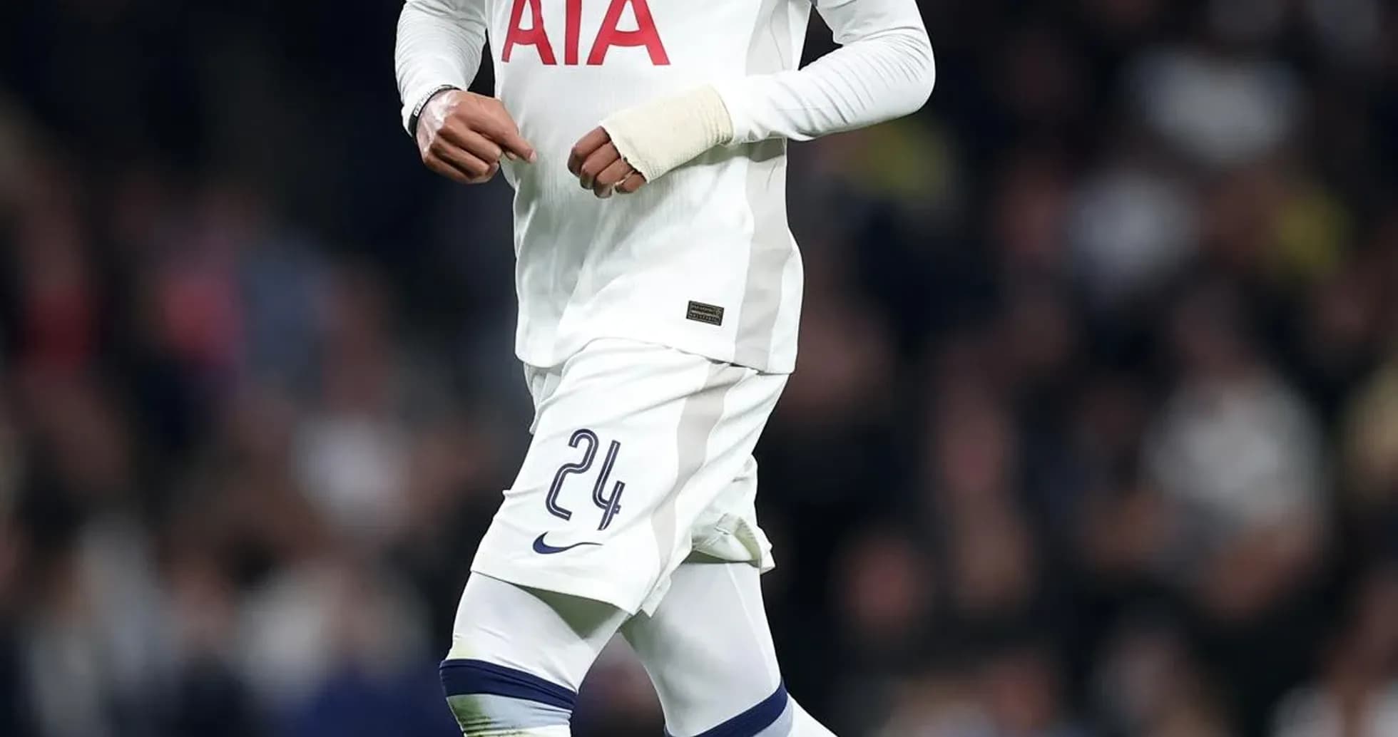 Player in Tottenham kit running with soccer ball