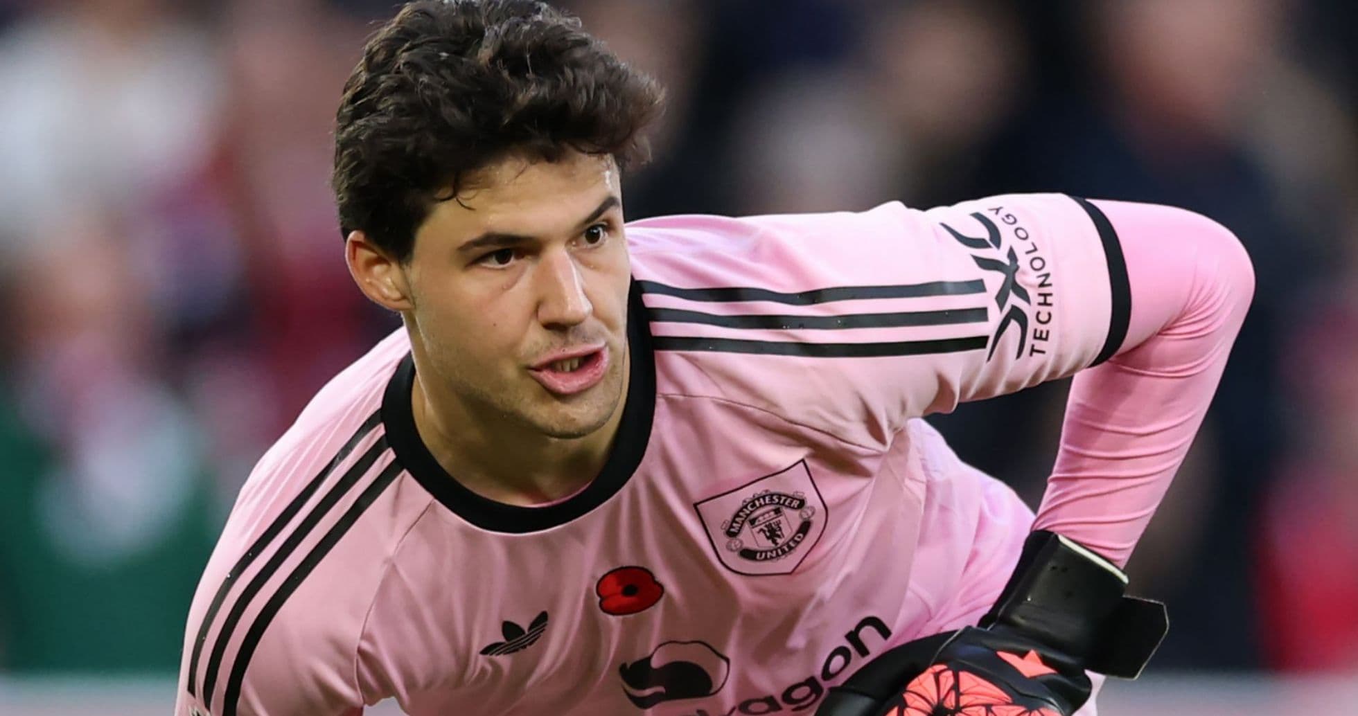 Goalkeeper in pink uniform preparing for play
