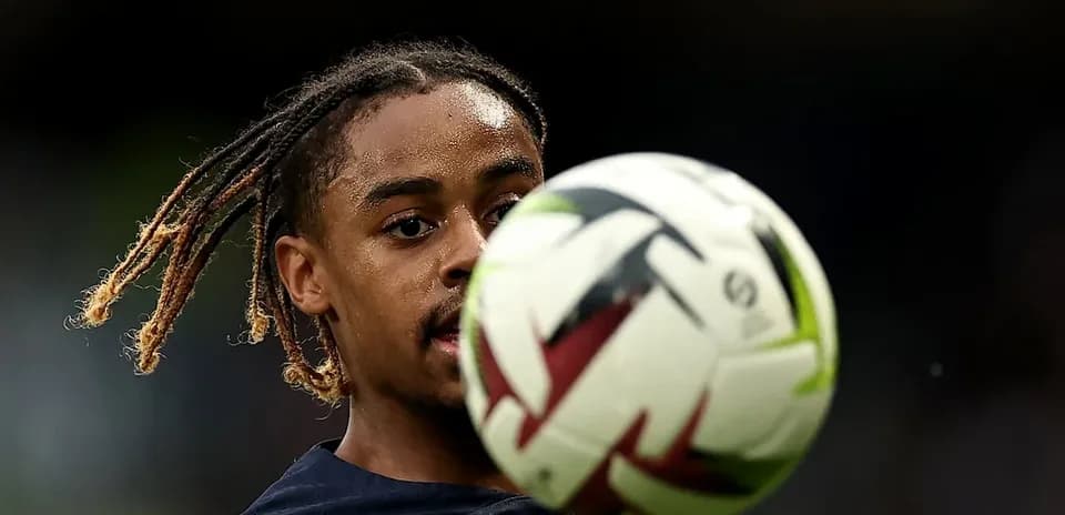 Player controlling a soccer ball during warm-up