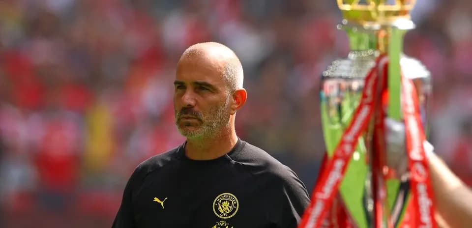 Coach walking past trophy during match ceremony
