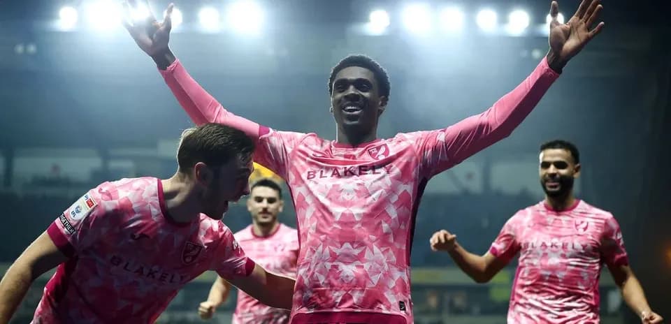 Players celebrating after scoring a goal during match