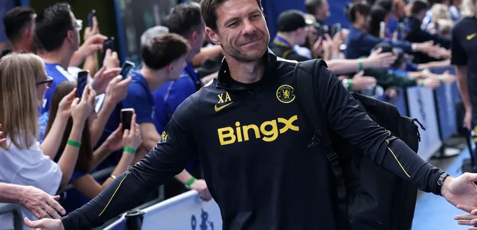 Coach greeting fans outside stadium before match