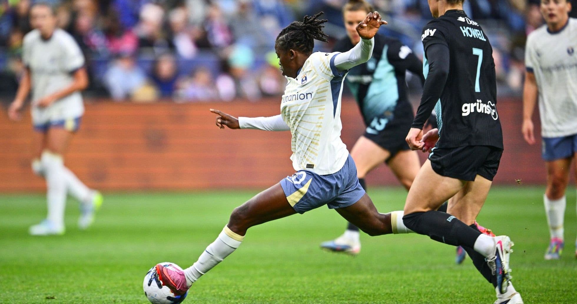 Seattle Reign FC player kicking the ball