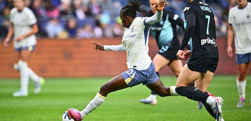 Seattle Reign FC player kicking the ball