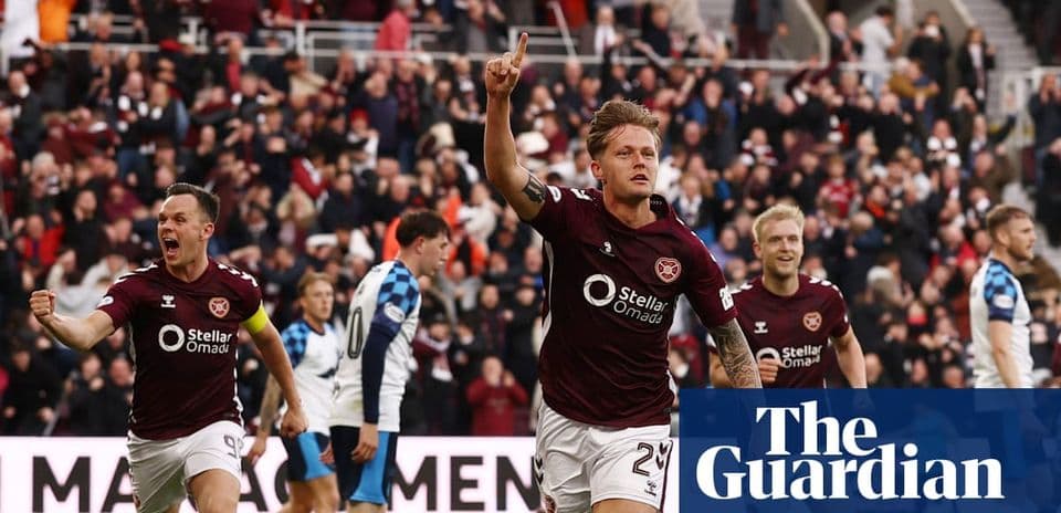 Hearts player celebrating goal with teammates in stadium