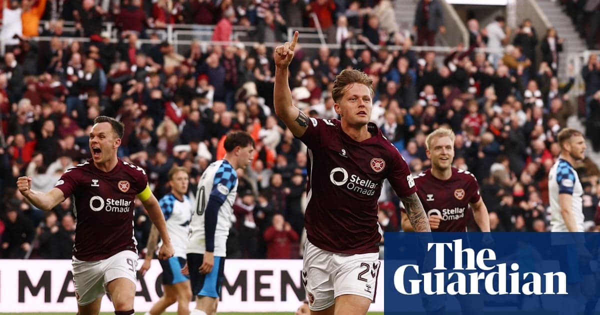 Hearts player celebrating goal with teammates in stadium
