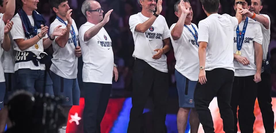 Coaches celebrating with team during victory ceremony