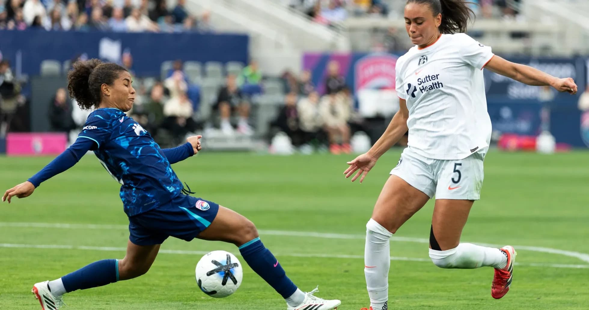 Players competing for the ball during NWSL match