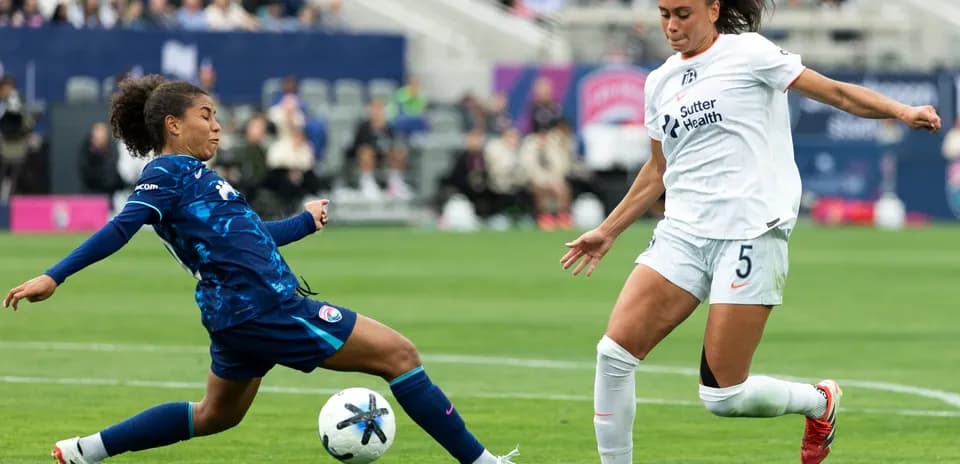 Players competing for the ball during NWSL match