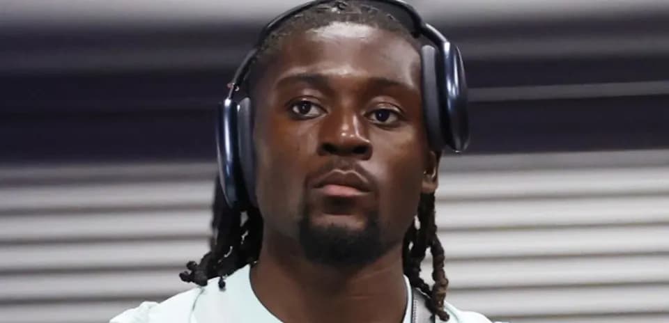 Player wearing headphones while entering venue