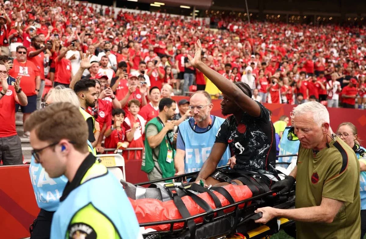 Player being carried on stretcher with crowd cheering