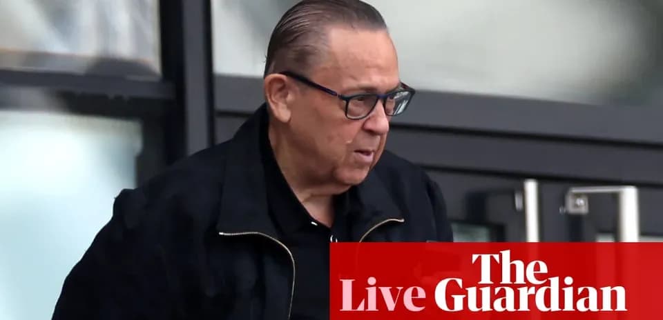 Man exiting building wearing glasses and black jacket