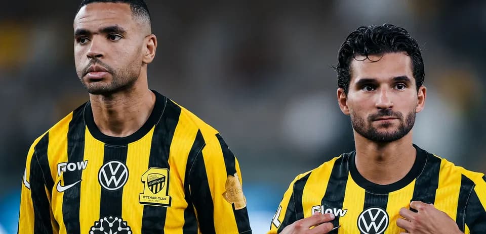 Two players wearing black and yellow team jerseys