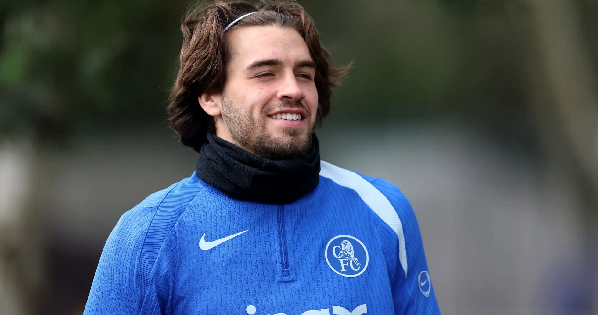 Player in blue training kit smiling during practice