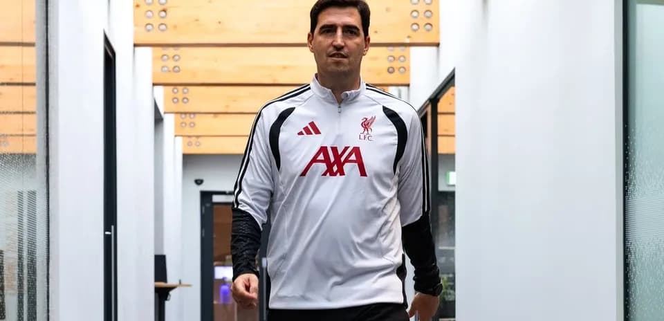 Coach walking through training facility corridor
